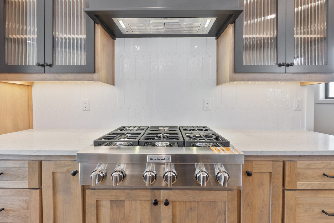 KitchenAid 6-burner gas cooktop with vented exhaust — luxury kitchen Rexburg Idaho