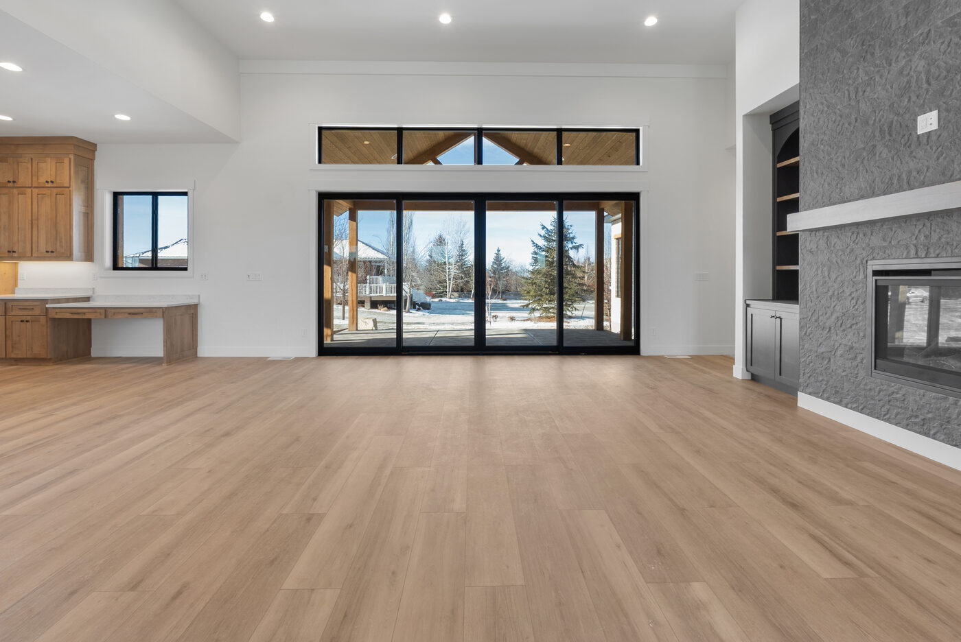 Expansive sliding glass doors with vaulted ceiling and timber accents